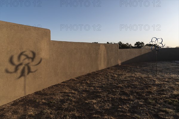 Barren desert garden with decorative wind spinner