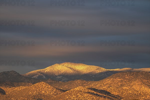 Light snow on Sangre de Cristo Mountains at sunset