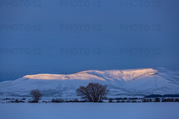 USA, Idaho, Bellevue, Snow covered field and hills at sunrise