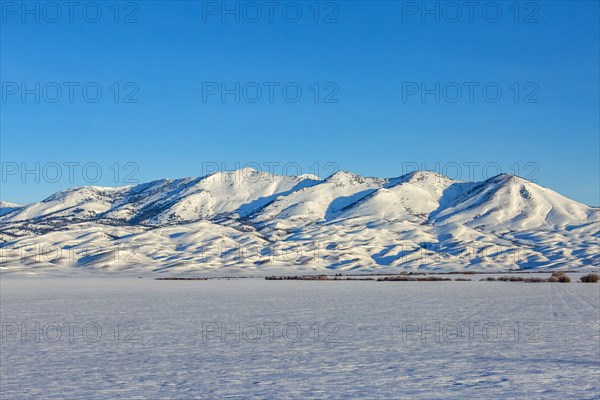 Snow covered field and Soldier Mountain on sunny day