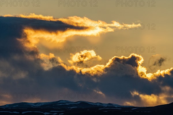 Dramatic sunset sky above hills