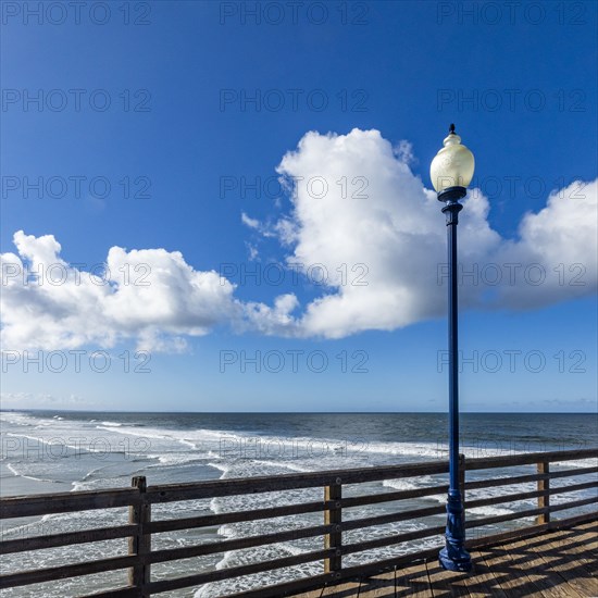 Pier in sea on sunny day