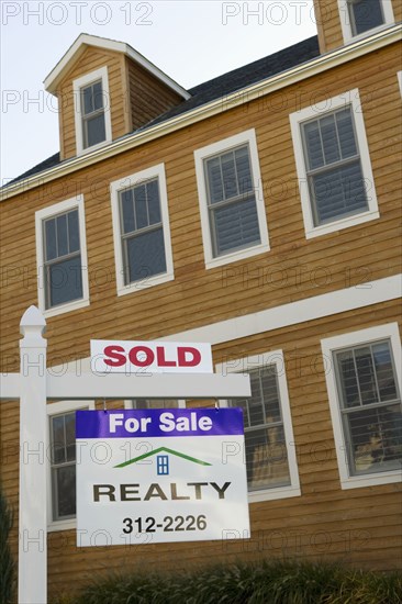 Sold sign in front of house