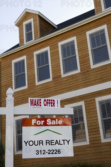 For Sale sign in front of house