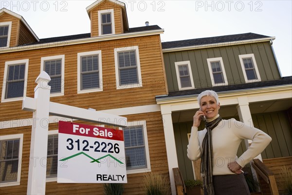 Real Estate agent in front of house