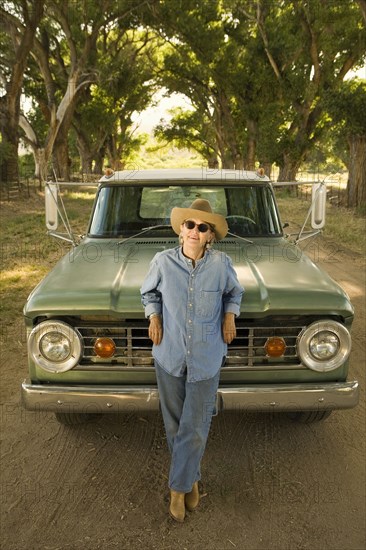 Woman leaning on pick-up truck