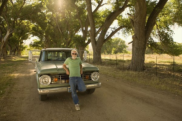 Man leaning on pick-up truck