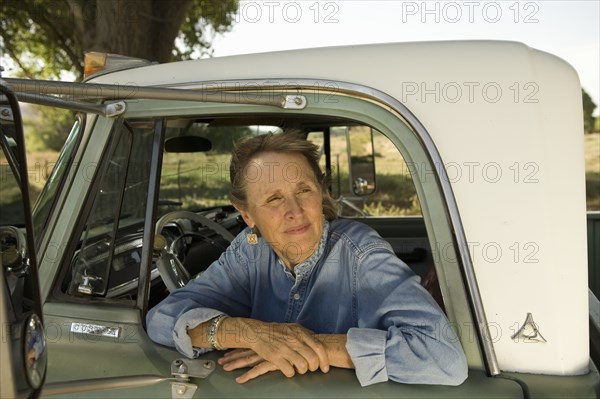 Senior woman in pick-up truck