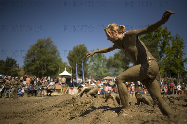 Sportswoman running in mud