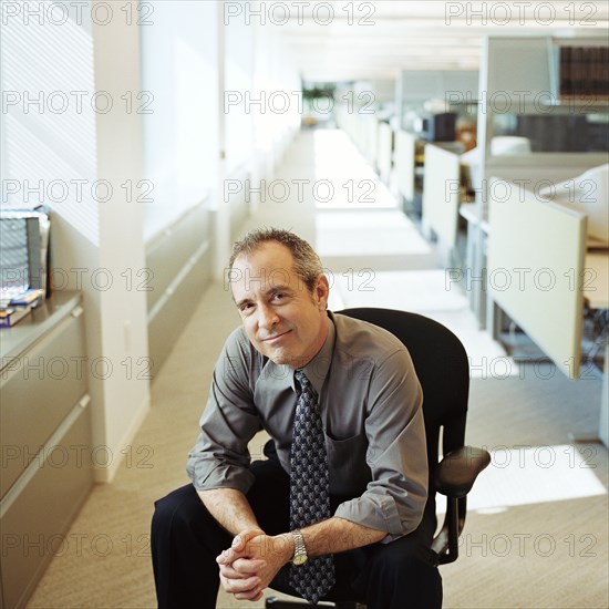 Businessman sitting on chair in office