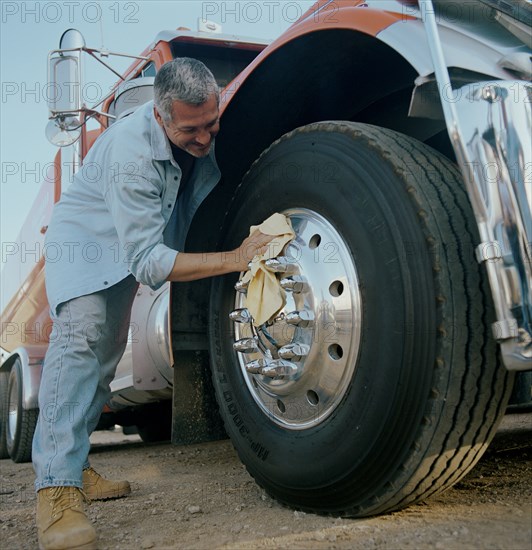 Truck driver cleaning is vehicle