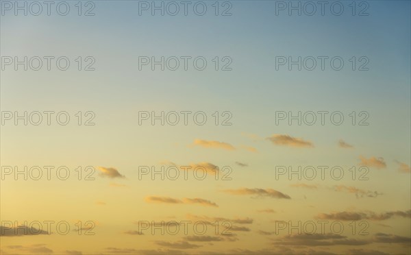 Blue sky with small calm clouds at sunrise