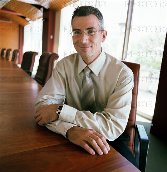 Portrait of businessman sitting in conference room