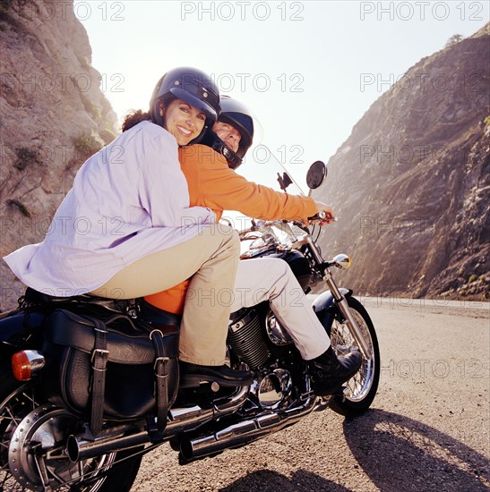 Couple riding motorcycle