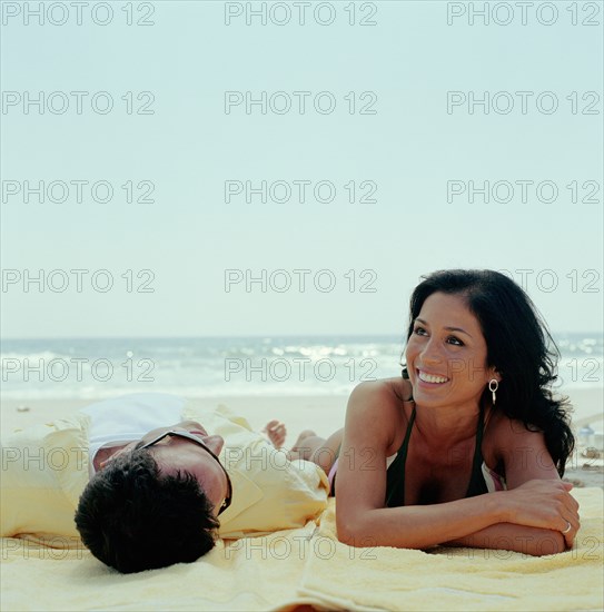 Couple lying on beach