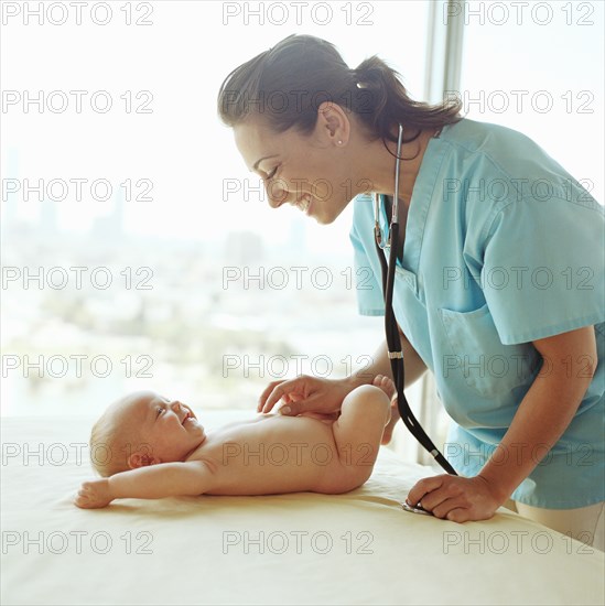 Doctor examining baby girl