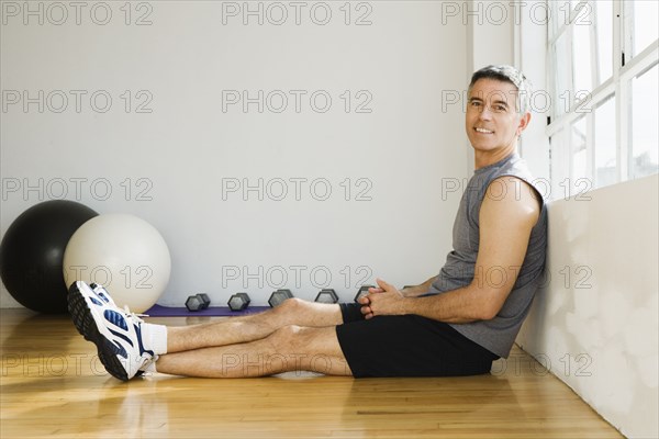 Portrait of man sitting in gym