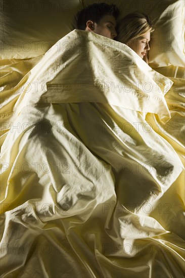 Young couple sleeping in bed