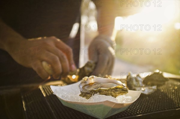 Man shucking fresh oysters