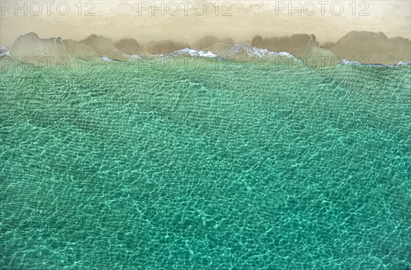 Overhead view of turquoise ocean and beach