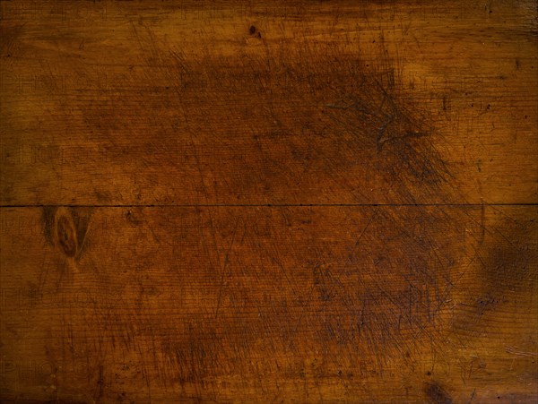 Close-up of worn antique cutting board with knife cut marks