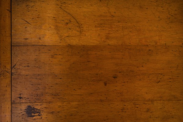 Close-up of worn antique cutting board with knife cut marks