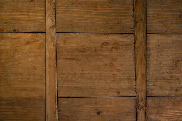 Close-up of worn antique cutting board with cross support wood slats