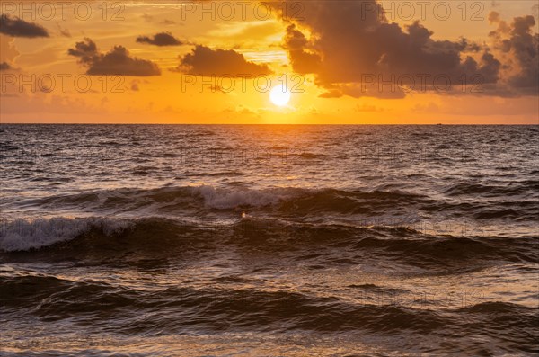 Sun rising over ocean