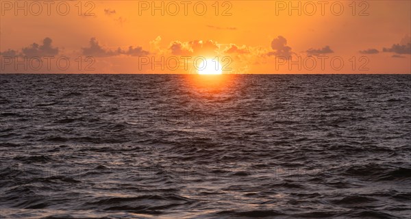 Sun rising over ocean