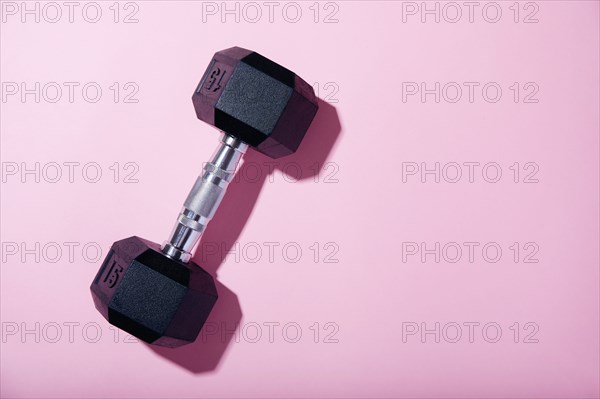 Dumbbell on pink background