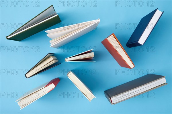 Overhead view of books on blue background