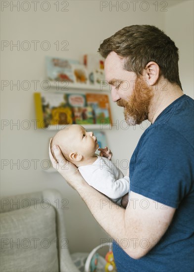 Father holding newborn son