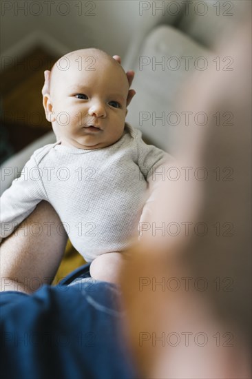 Close-up of father holding newborn son