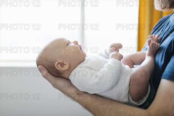 Close-up of father holding newborn son