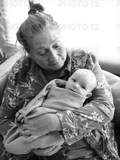 Grandmother holding newborn grandson
