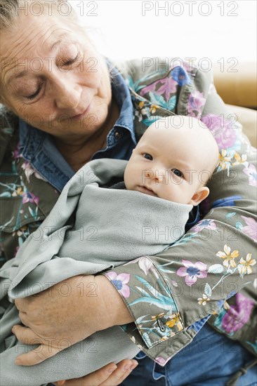 Grandmother holding newborn grandson