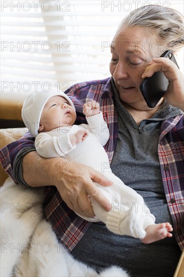 Grandmother holding newborn grandson