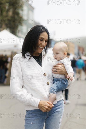 Grandmother holding baby grandson