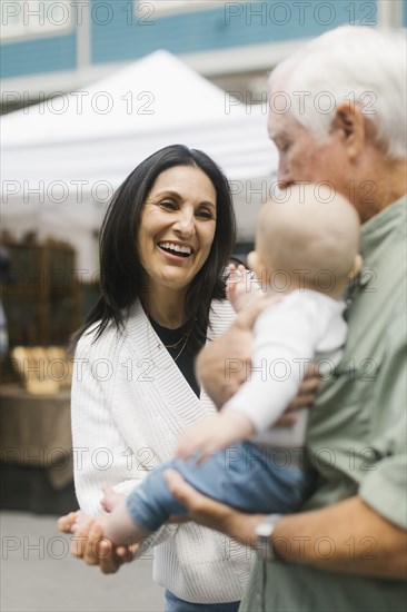 Grandparents holding baby grandson