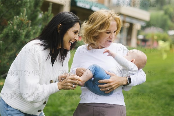 Grandmothers holding baby grandson