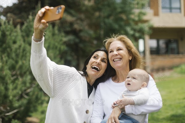 Grandmothers taking selfie with baby grandson