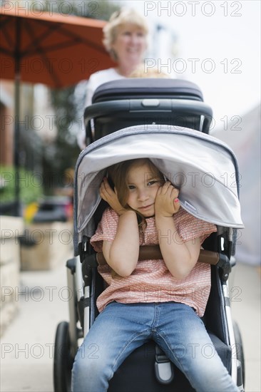 Grandmother with sulking granddaughter