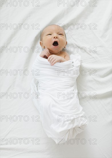 Swaddled newborn boy