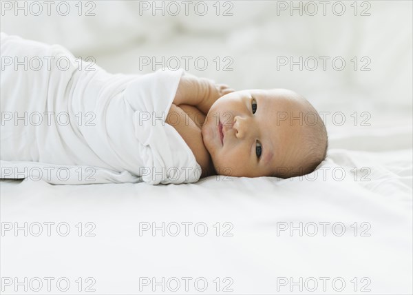 Portrait of swaddled newborn boy