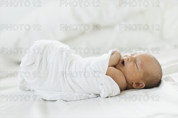 Swaddled newborn boy