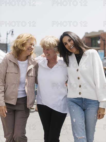 Three women walking down street