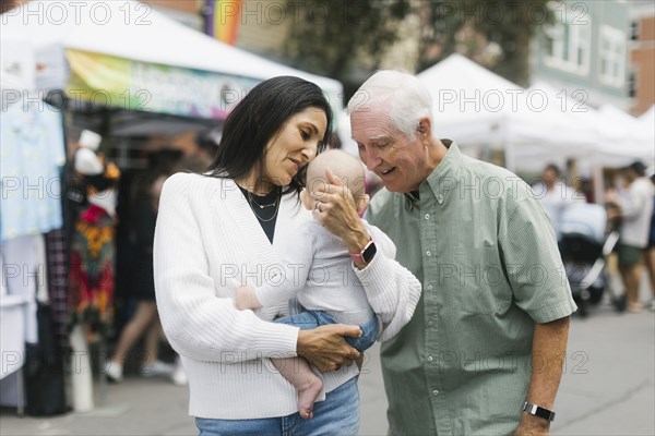 Grandparents holding baby grandson