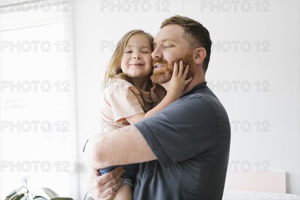 Father holding daughter