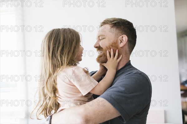 Father holding daughter