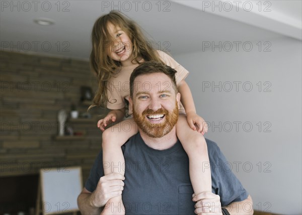 Father carrying daughter